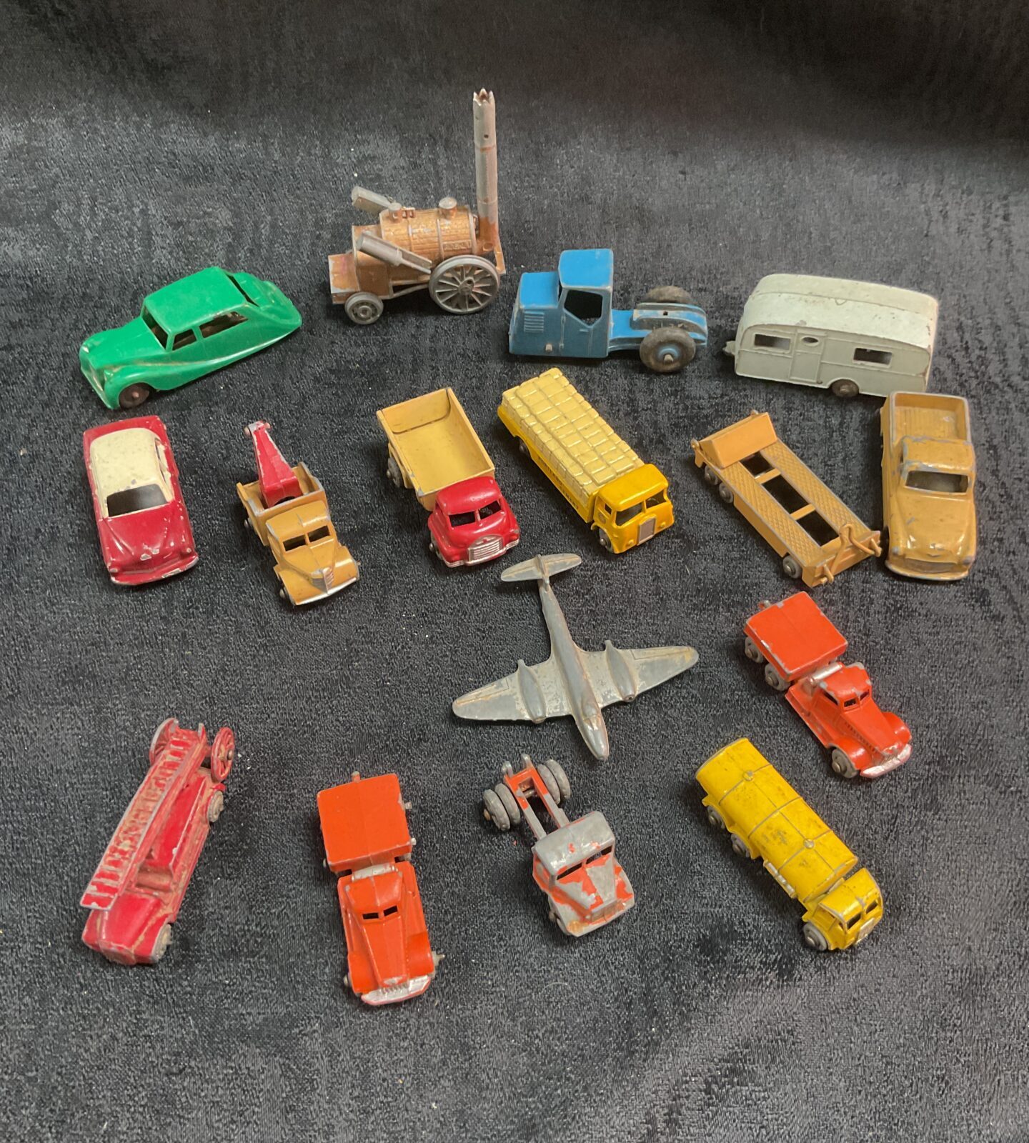 Overview of a vintage diecast vehicle lot with various cars and trucks.