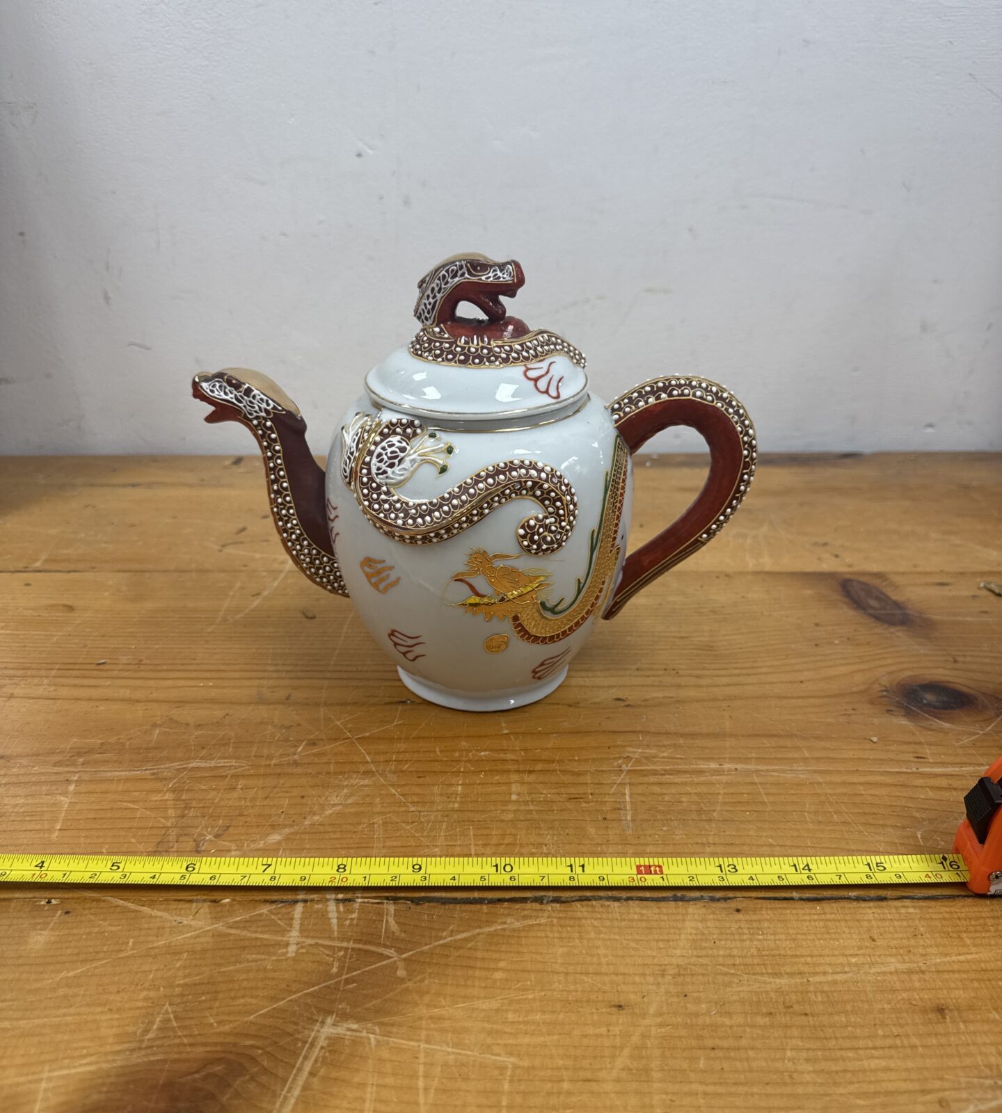Vintage oriental dragon teapot with detailed ceramic sculpting.