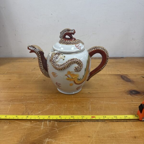 Vintage oriental dragon teapot with detailed ceramic sculpting.