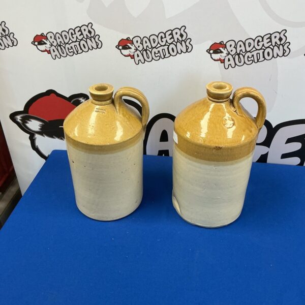 Two vintage earthenware flagons with a rustic aesthetic.