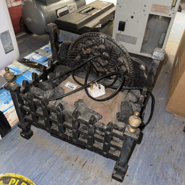 Vintage electric fire grate with ornate detailing.