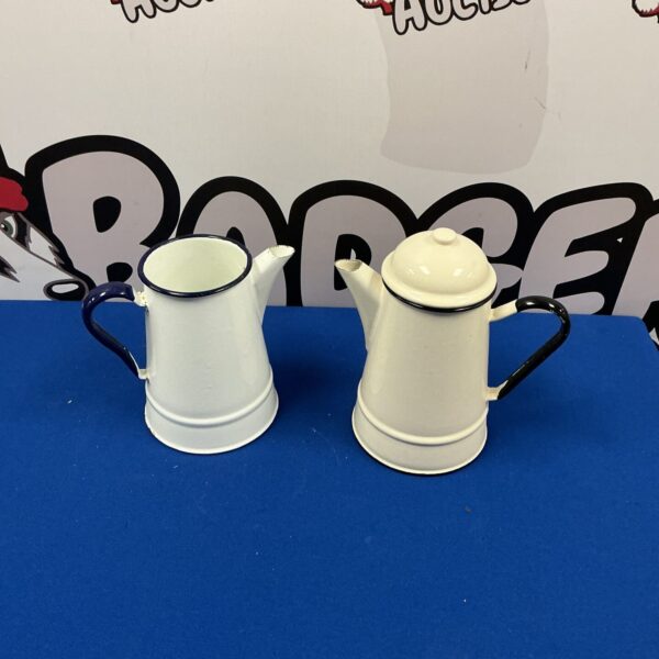 Pair of vintage enamel jugs for kitchen display.