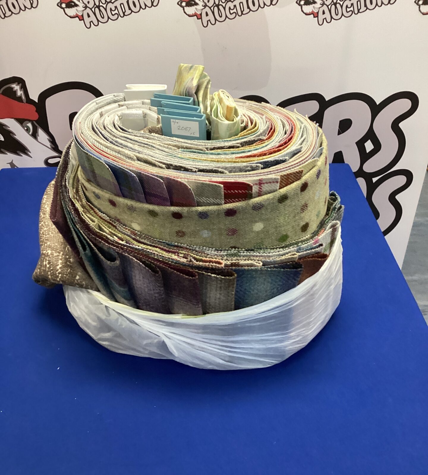 Vintage fabric sample folders with colourful textile swatches.