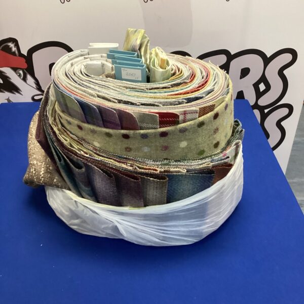 Vintage fabric sample folders with colourful textile swatches.