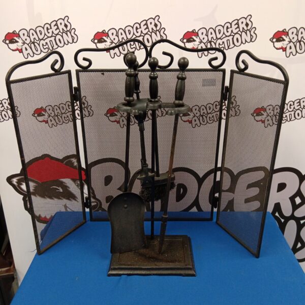Vintage fireplace companion set with cast iron tools and mesh screen.