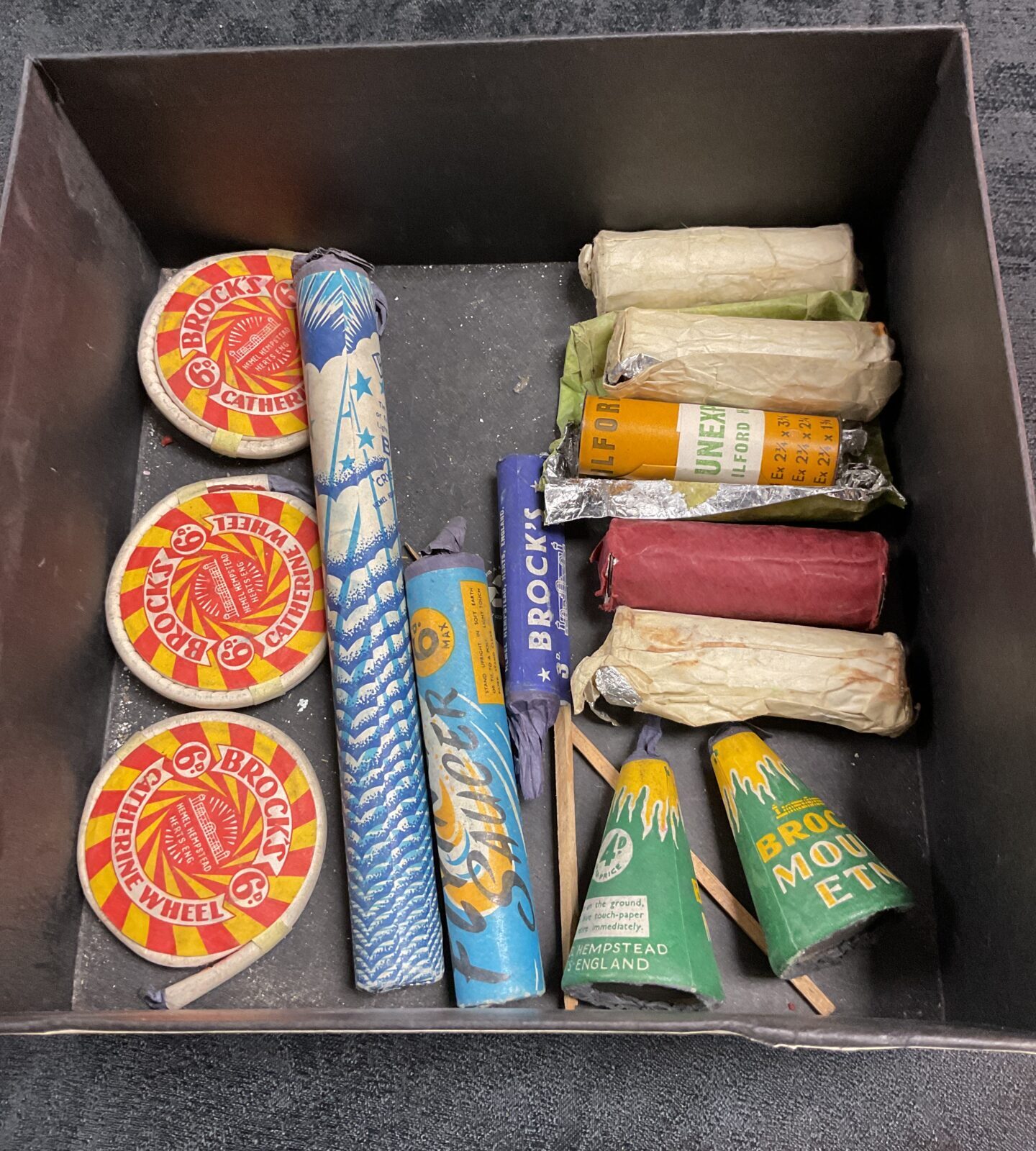 Vintage lot of fireworks and unexposed Ilford film rolls.