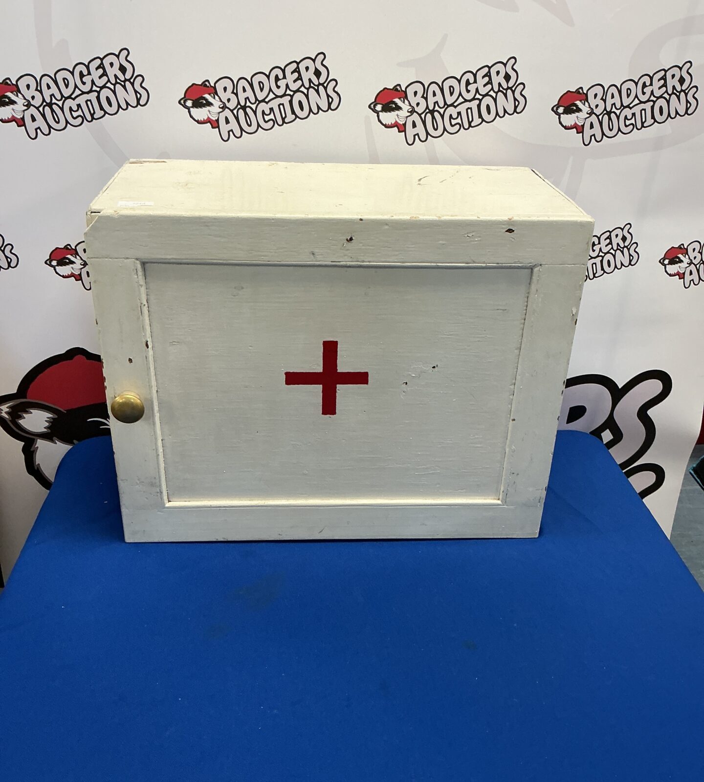 Vintage wooden first aid cabinet with a classic design.