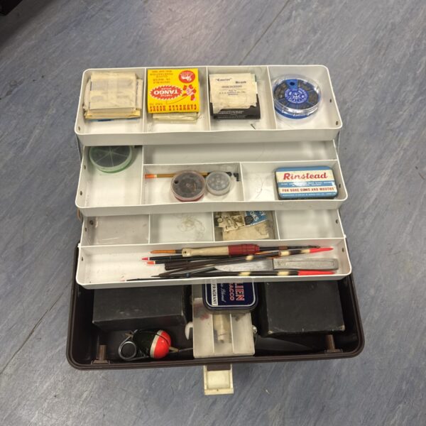 Vintage fishing tackle box filled with lures and accessories.