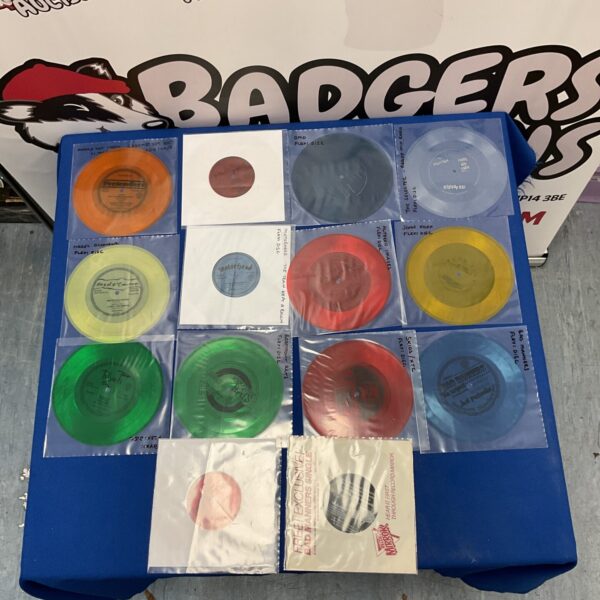 Vintage flexi disc collection featuring Depeche Mode, Skids, and Motorhead.