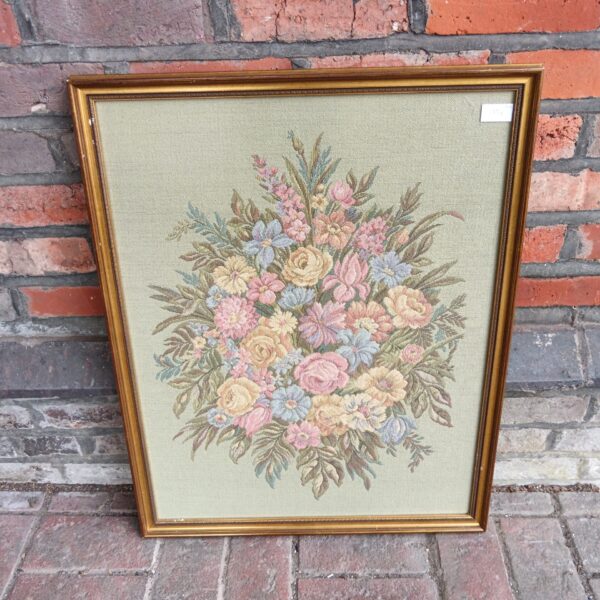 Large vintage floral embroidery framed in gold, detailed needlepoint.
