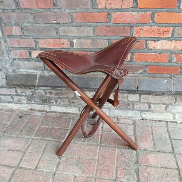 Vintage leather folding tripod chair with wooden frame.