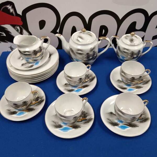 Full vintage geisha teaset with teapot, cups, and saucers.