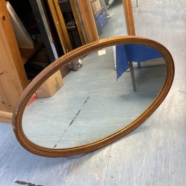 Vintage gilt framed oval mirror measuring 100x65cm for wall decor.