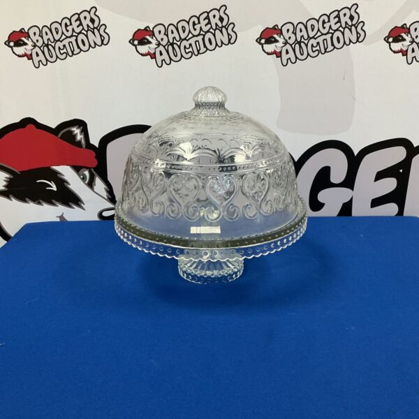 Elegant vintage glass cake stand with a clear dome cover.