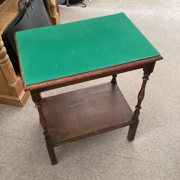 Vintage hall table with green fabric top and turned legs.