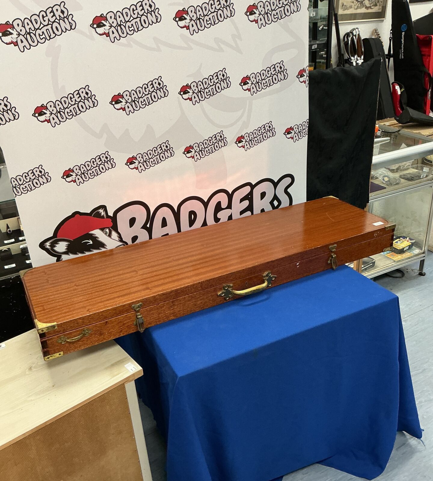 Front view of a vintage wooden gun case with "BADGERS" inscription.