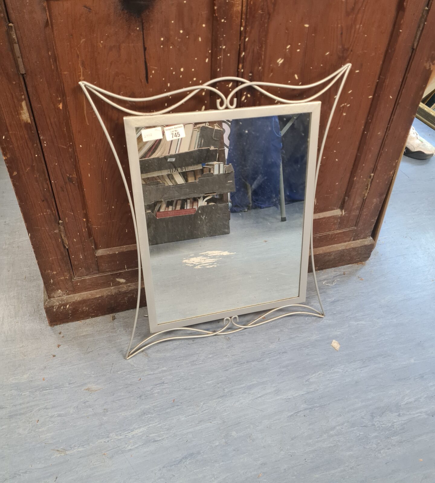 Vintage hall mirror with ornate metal frame, ideal for hallway decor.