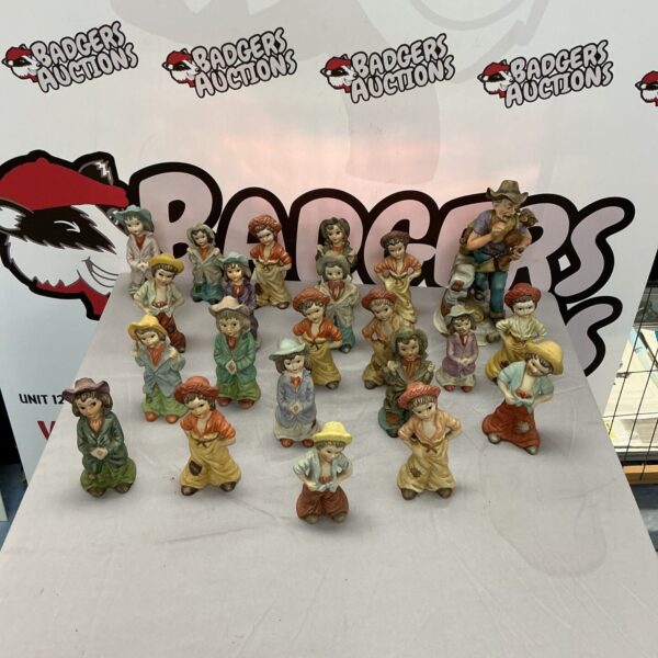 Vintage hand painted ceramic figures including Brinns collectibles on display.