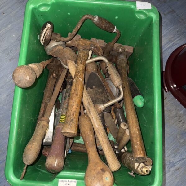 Collection of vintage hand tools with wooden handles.