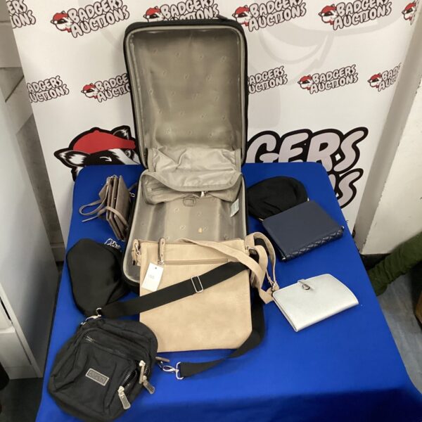 Vintage suitcase filled with assorted handbags and luggage.