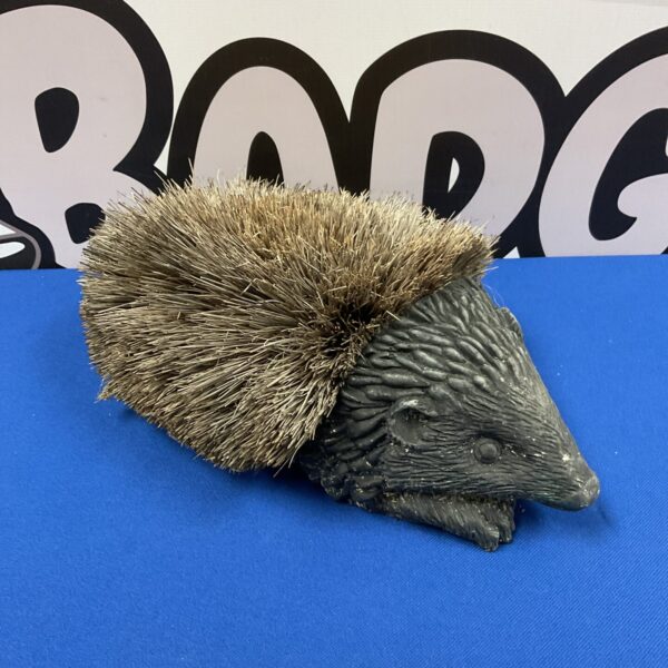 Vintage cast iron hedgehog boot brush for cleaning footwear.
