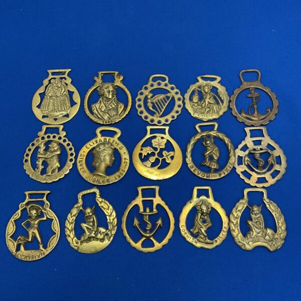 Vintage horse brasses with Irish Pisky designs, collectible equestrian antiques.
