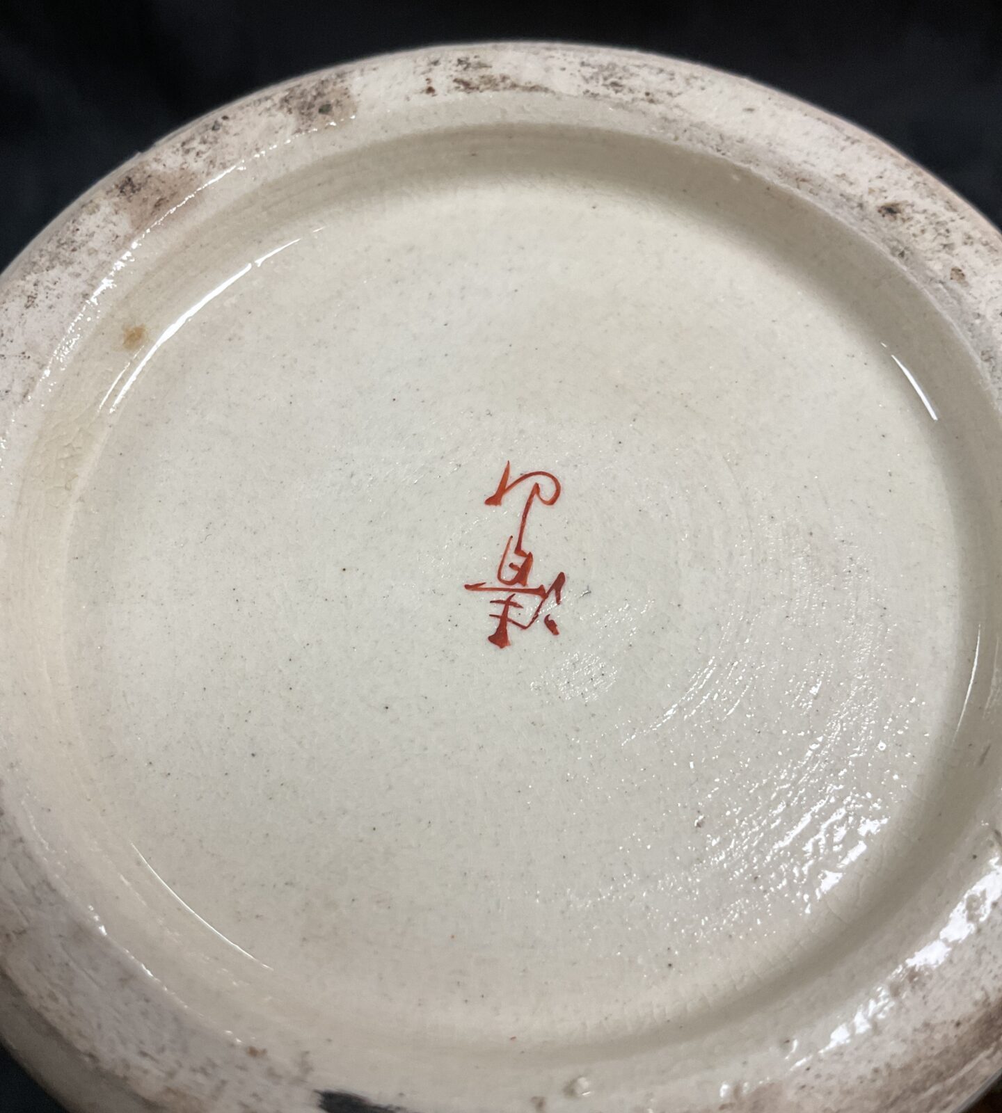 Close-up of a vintage Japanese Satsuma vase with figure artwork.