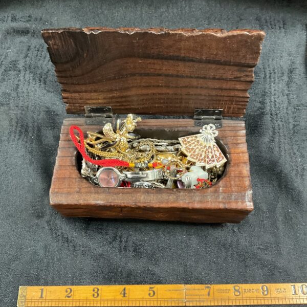 Vintage carved wood jewellery box filled with costume jewellery.