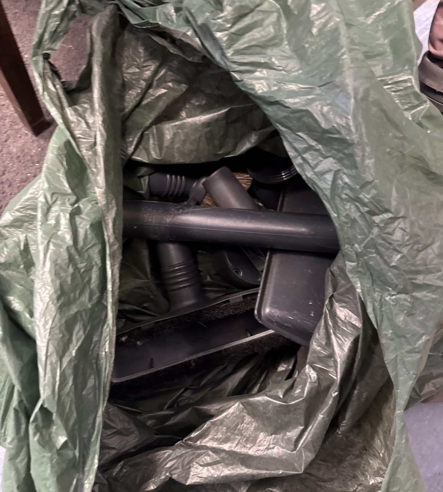 Close-up of attachments included with the vintage Kirby vacuum cleaner.