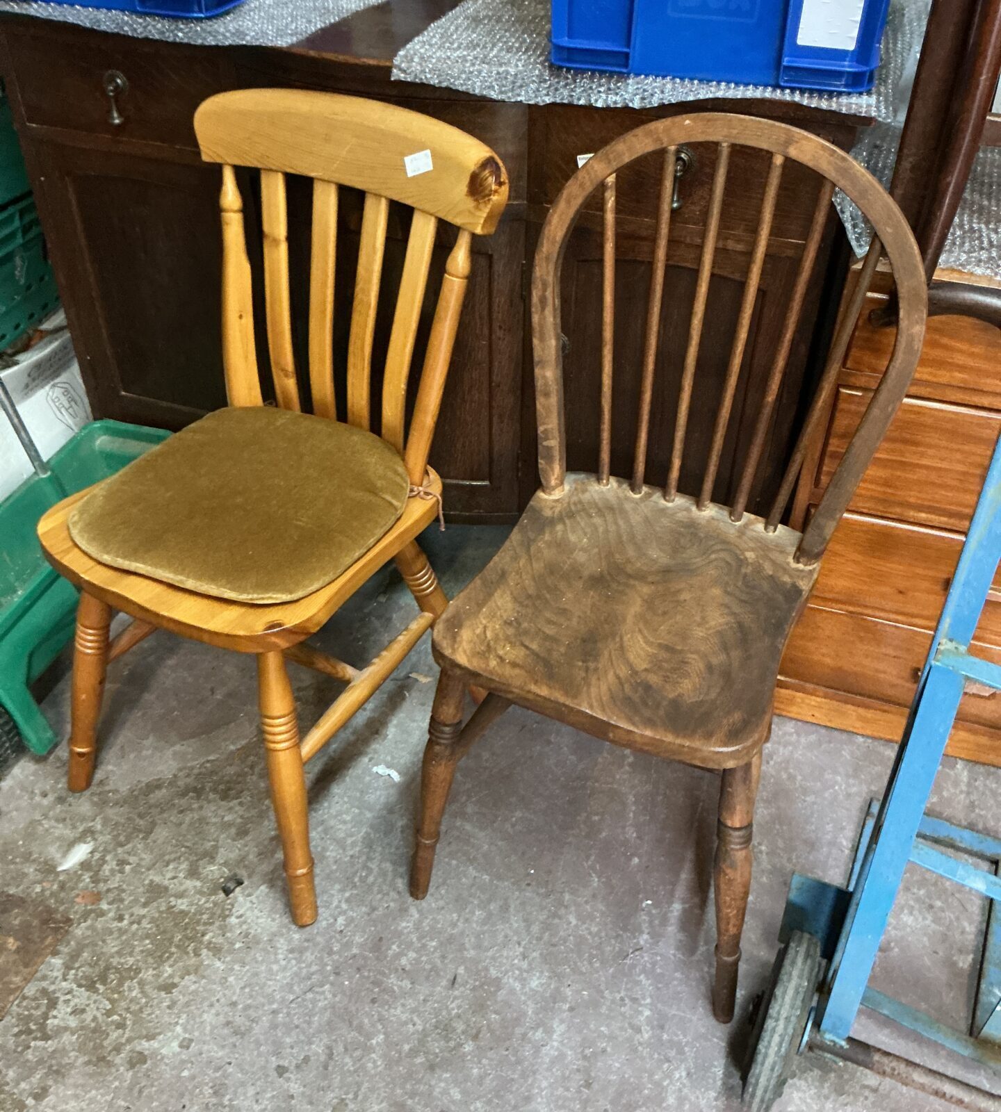 Pair of vintage wooden kitchen chairs with padded seats.