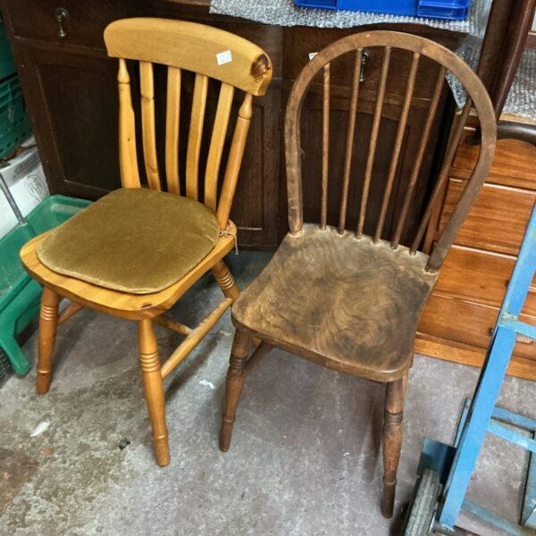 Pair of vintage wooden kitchen chairs with padded seats.