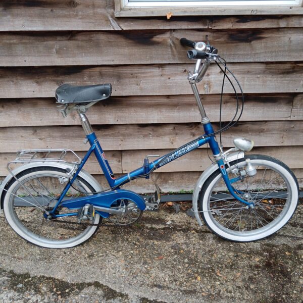 Blue vintage ladies folding bicycle with chrome details.