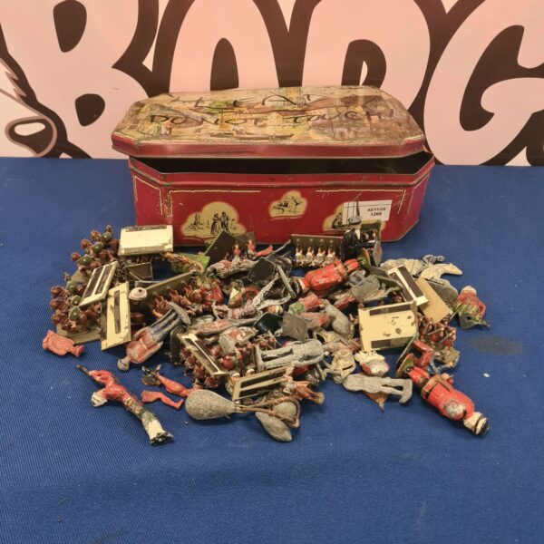 Vintage lead figurines in a decorative tin box, collectible toy soldiers.
