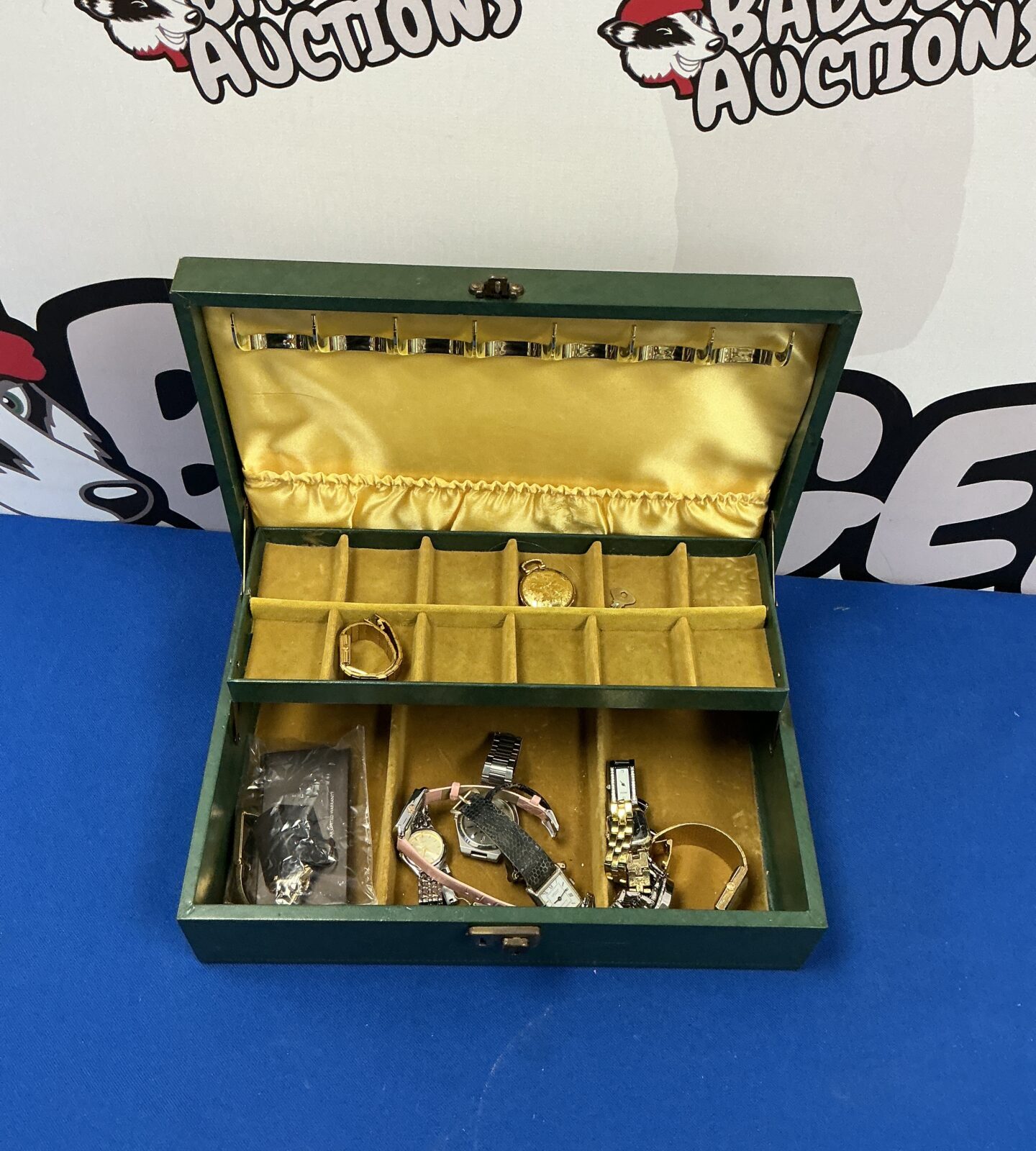 Open vintage leather jewellery box with velvet lining and contents.