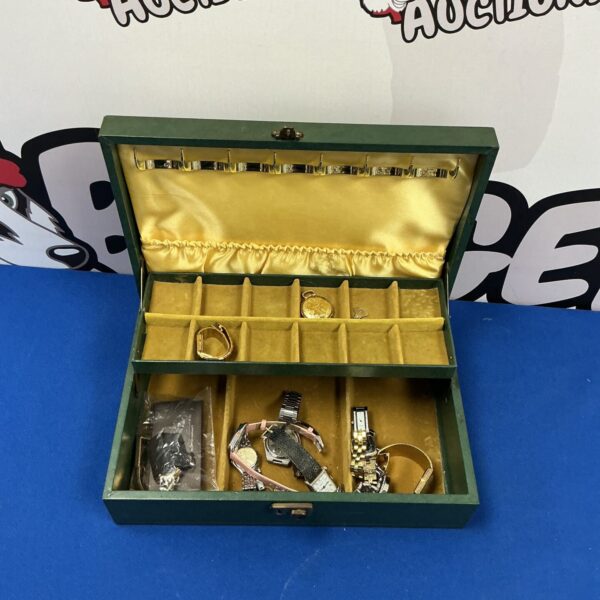 Open vintage leather jewellery box with velvet lining and contents.