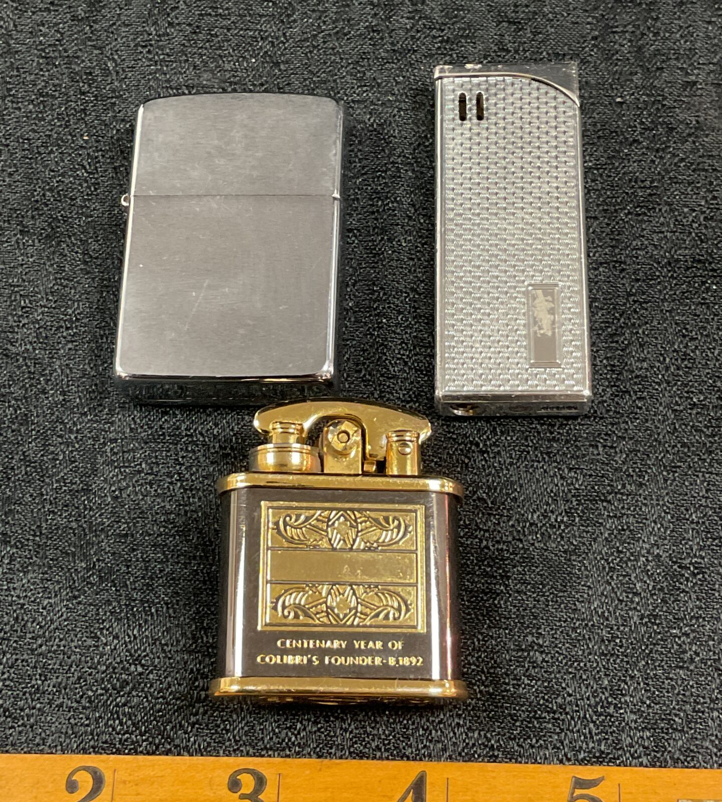 Vintage cigarette lighters including Colibri, Zippo, and Ronson brands.