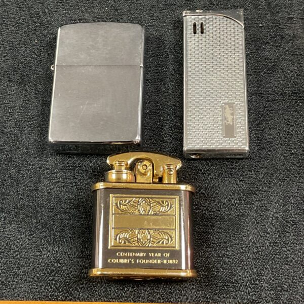 Vintage cigarette lighters including Colibri, Zippo, and Ronson brands.
