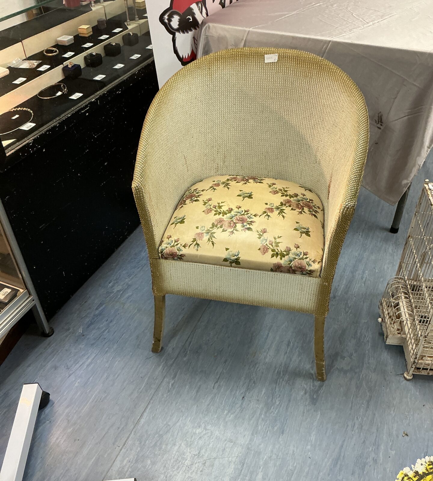 Vintage Lloyd Loom chair with floral upholstery, a charming retro seating option.