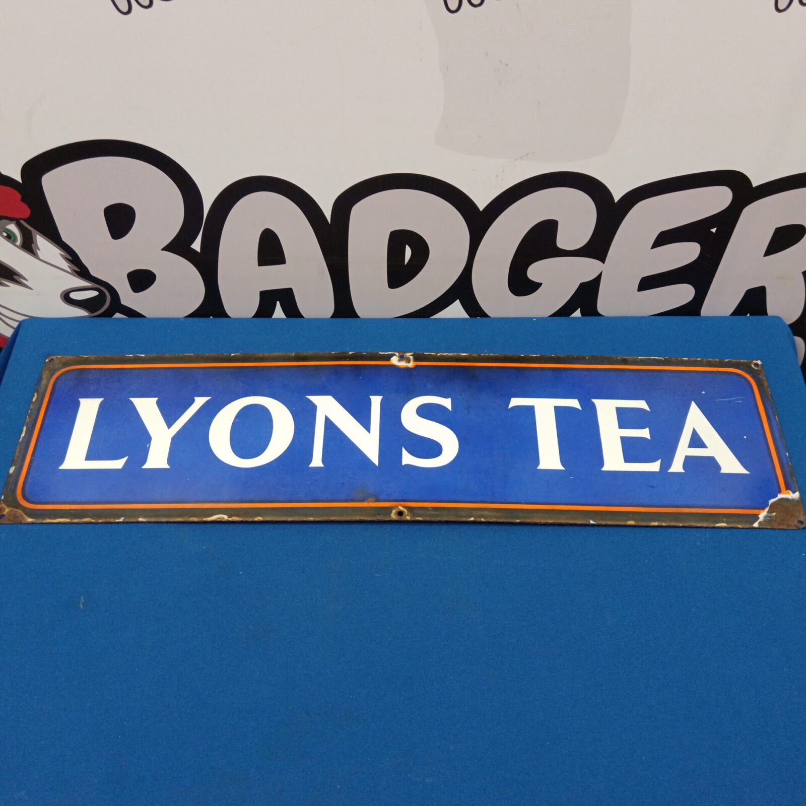 Front view of a vintage Lyons Tea enamel advertising sign.