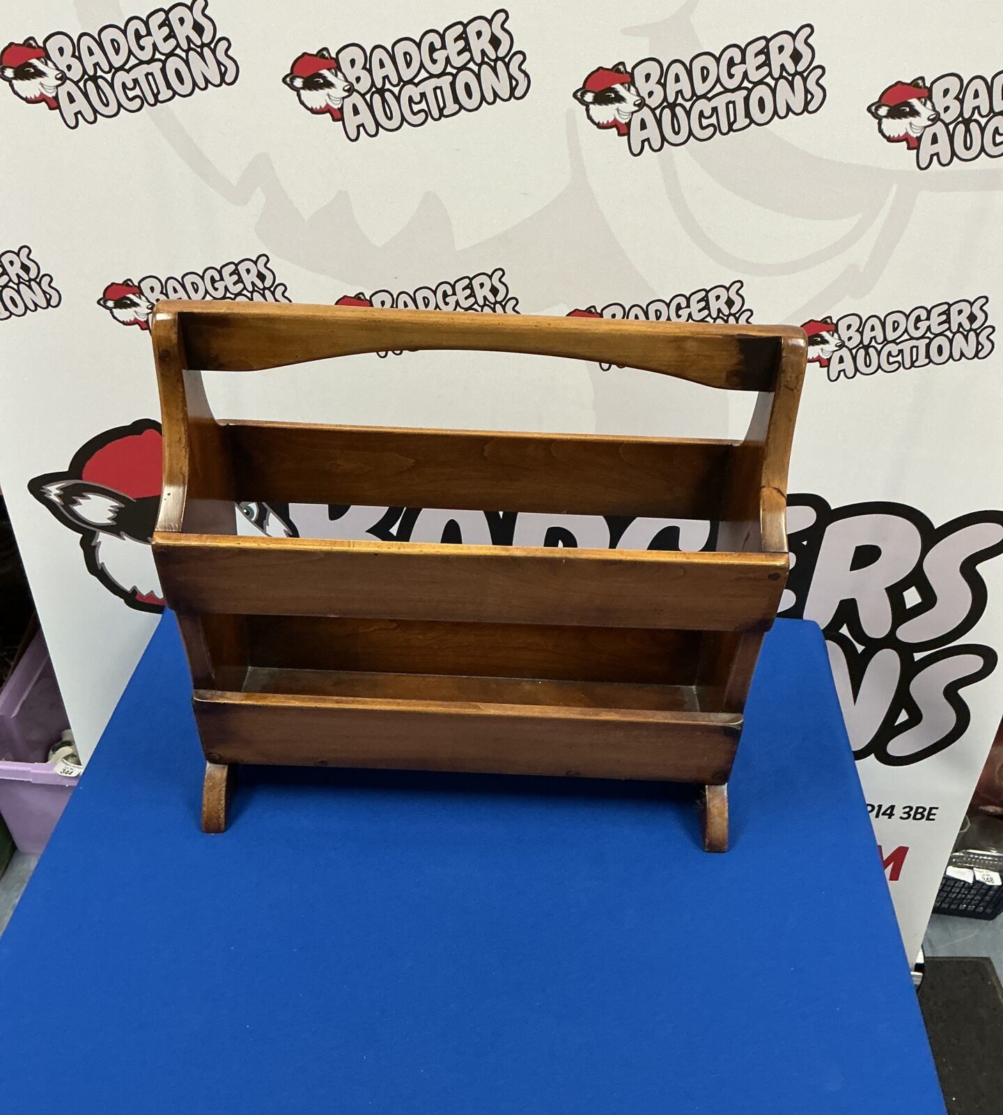 Vintage wooden magazine rack with four compartments.