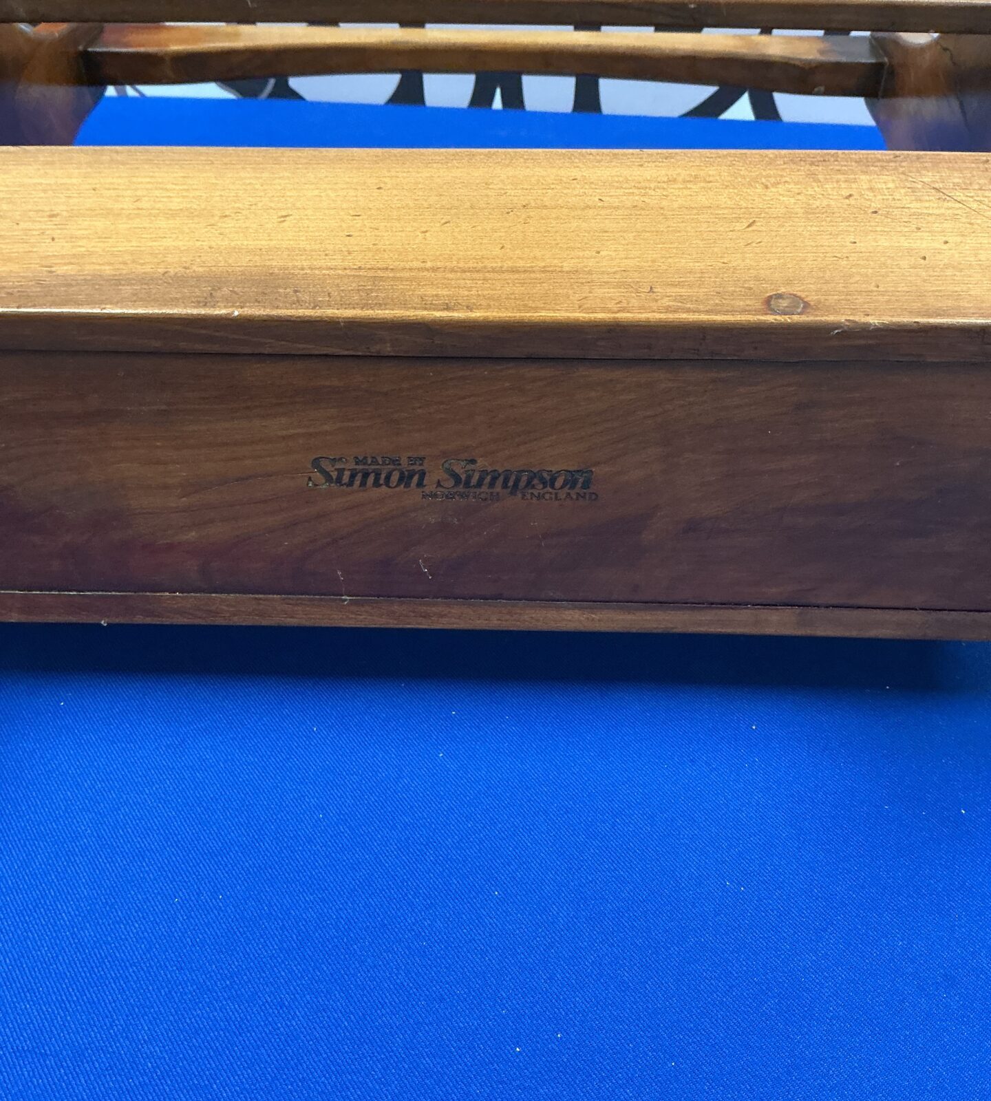Side view of vintage wooden magazine rack.