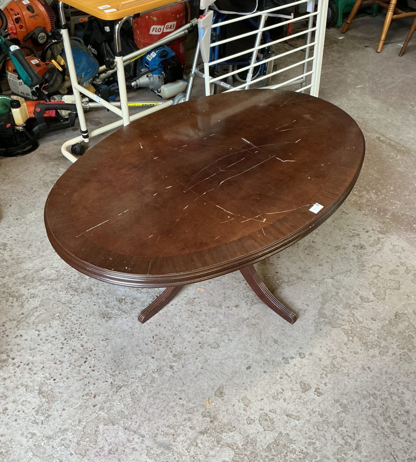 Vintage mahogany coffee table in a workshop setting.