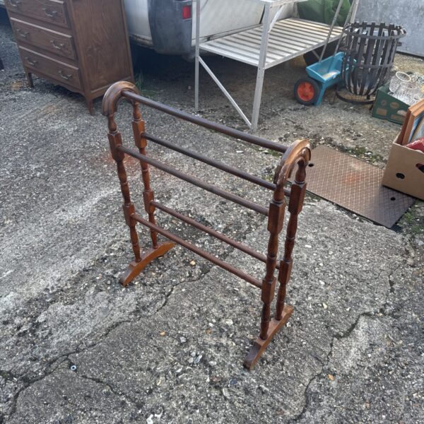 Front view of a vintage mahogany towel rail.
