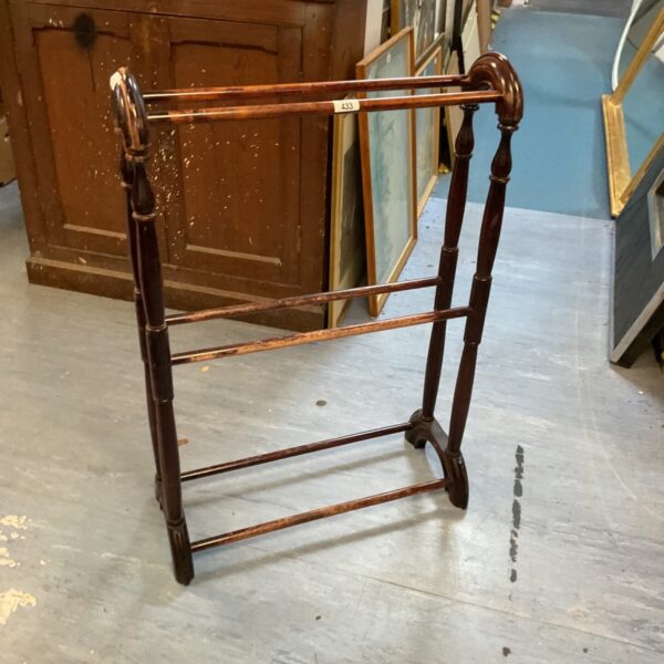 Vintage mahogany towel rail with three bars for bathroom storage.