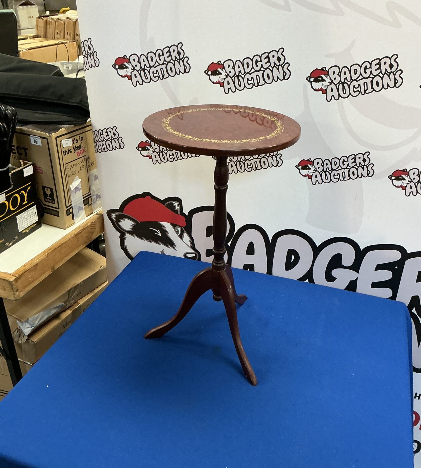 Vintage mahogany three-legged wine table in good condition.