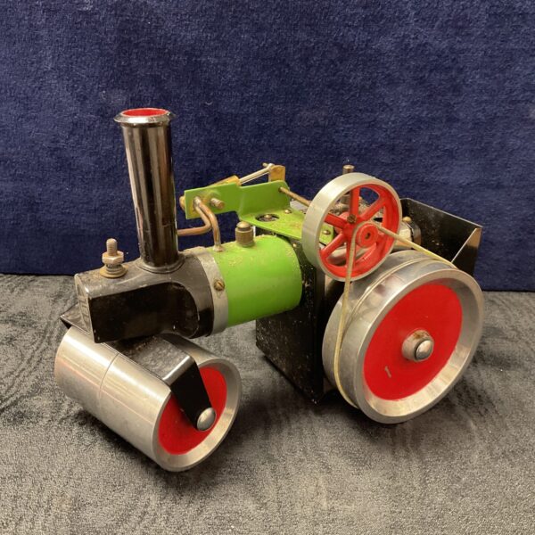Vintage Mamod steam roller with red wheels and black frame.