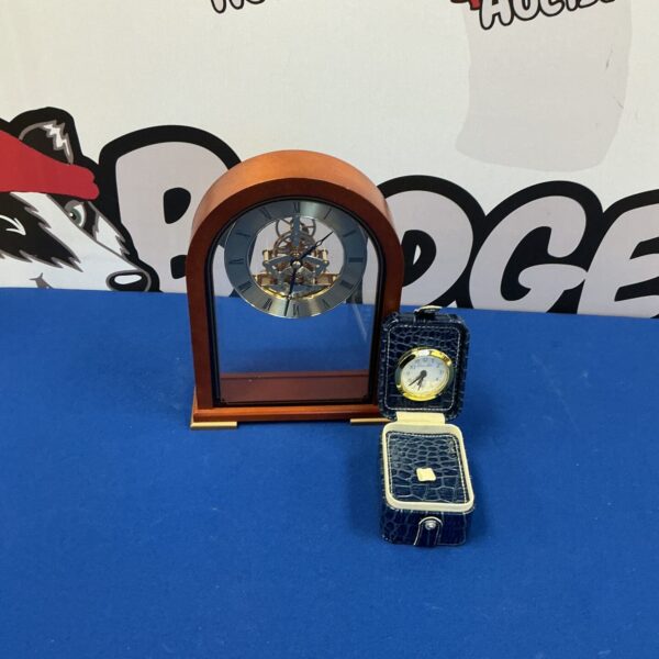 Vintage mantle clock set with travel clock on display.