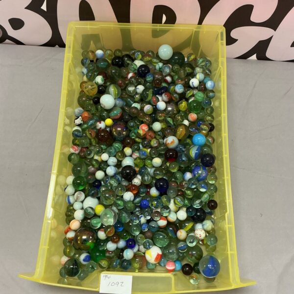Colourful vintage marbles in a tray, antique glass toy collection.