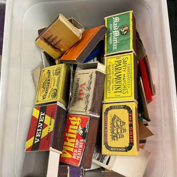 Vintage matchbox collection with assorted designs and branding.