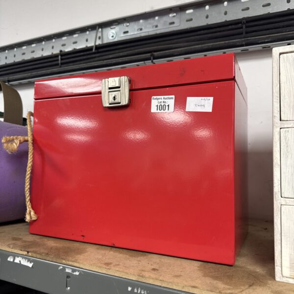 Vintage metal filing box with a locking mechanism for document storage.